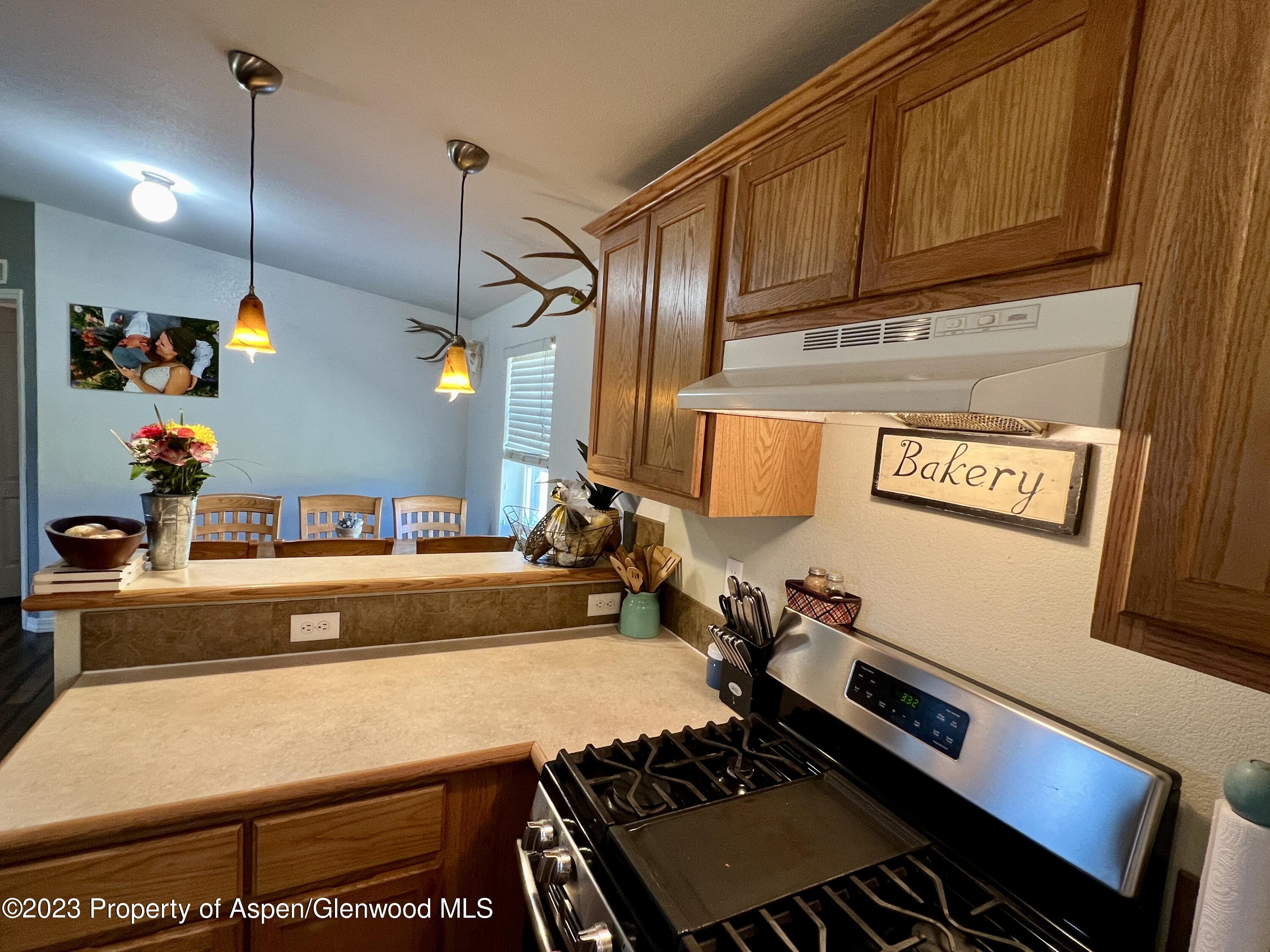 a room with stainless steel appliances kitchen island a stove and a refrigerator