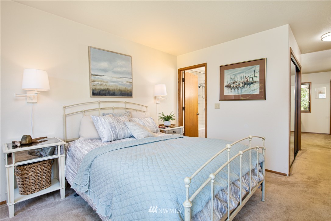 3115 Biz Point Road Anacortes, WA 98221 - Photo 15 of 39 a bedroom with a bed and a lamp on table