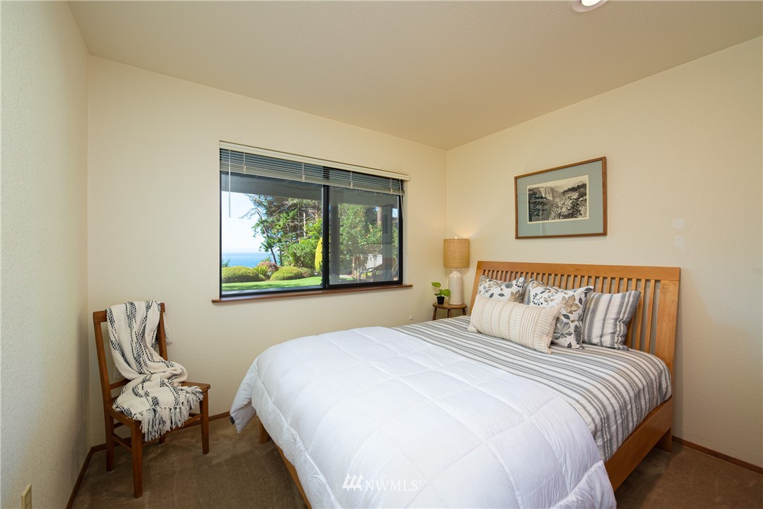 3115 Biz Point Road Anacortes, WA 98221 - Photo 22 of 39 a bedroom with a bed and chair