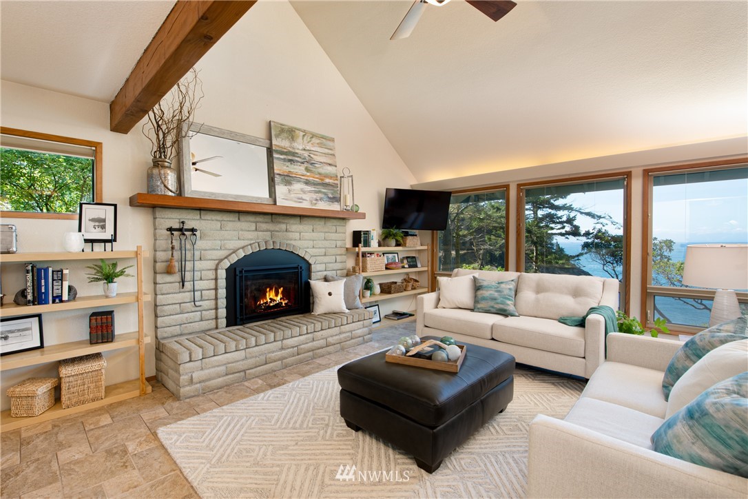 3115 Biz Point Road Anacortes, WA 98221 - Photo 7 of 39 a living room with furniture a large window and a fireplace