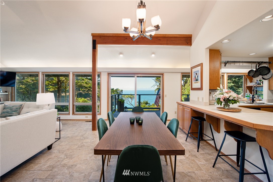 3115 Biz Point Road Anacortes, WA 98221 - Photo 10 of 39 a view of a dining room with furniture wooden floor and chandelier