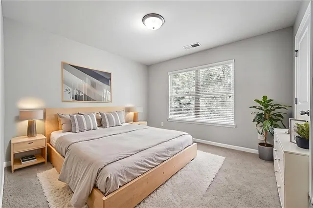 a bedroom with a large bed and a window