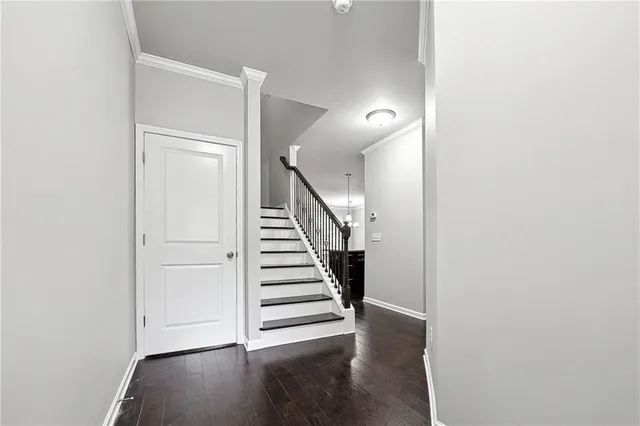 a view of entryway and hall with wooden floor