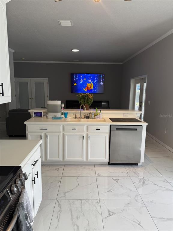 5690 Merlin Way St. Cloud, FL 34772 - Photo 11 of 46 a kitchen with a stove top oven and a sink