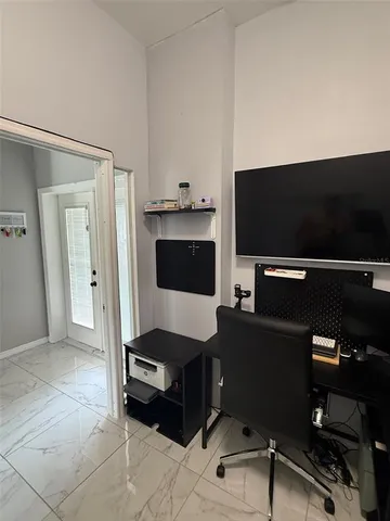 a room with a bed and a refrigerator