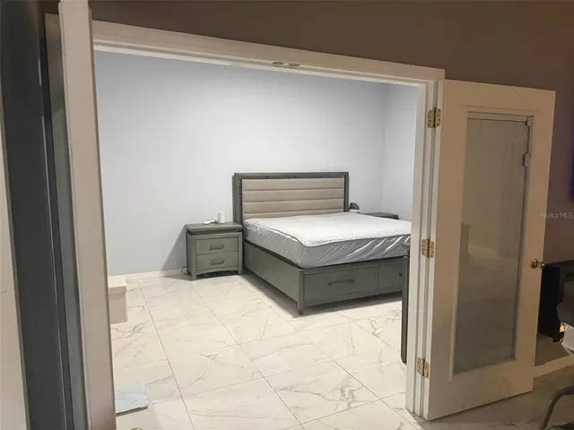 a bedroom with a bed and lamp