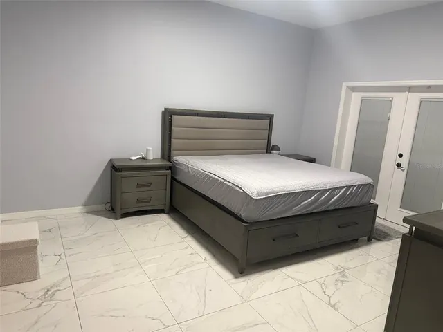 a bedroom with a bed and flat screen tv