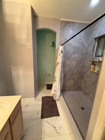 a bathroom with a toilet and a shower curtain