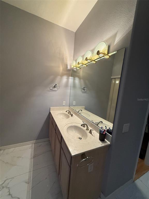 5690 Merlin Way St. Cloud, FL 34772 - Photo 23 of 46 a utility room with cabinets washer and dryer