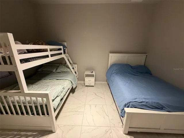 a bedroom with a bed and a television