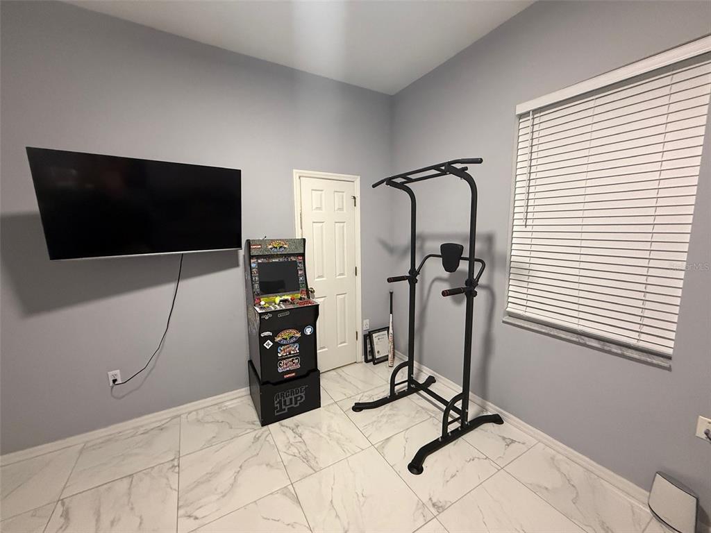 5690 Merlin Way St. Cloud, FL 34772 - Photo 31 of 46 a bedroom with a bed and a flat screen tv