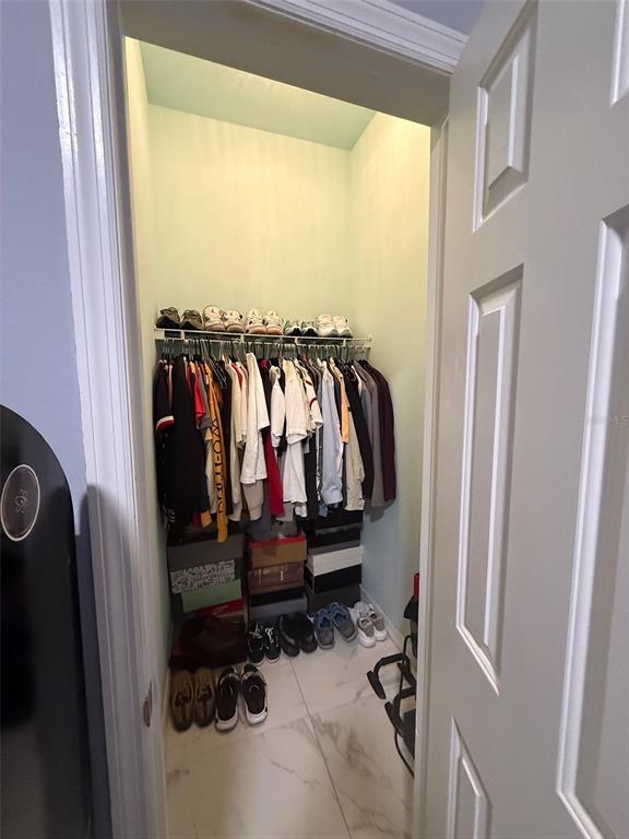 5690 Merlin Way St. Cloud, FL 34772 - Photo 33 of 46 a view of walk in closet with clothes and shoes
