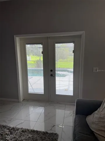 a view of a patio with table and chairs potted plants with wooden floor and fence