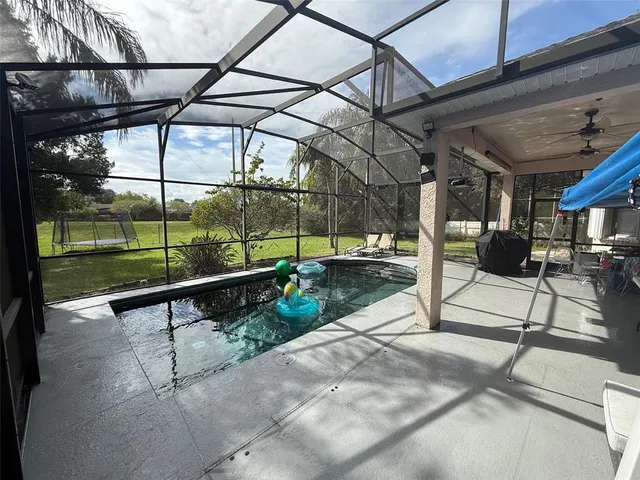 a view of swimming pool with a patio and a yard