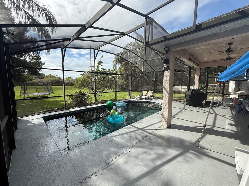 5690 Merlin Way St. Cloud, FL 34772 - Photo 37 of 46 a view of a swimming pool with a porch