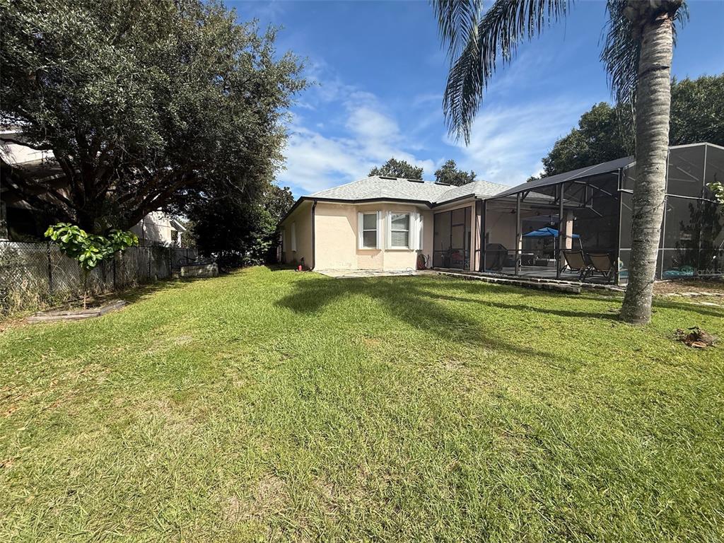 5690 Merlin Way St. Cloud, FL 34772 - Photo 40 of 46 a view of a house with a yard
