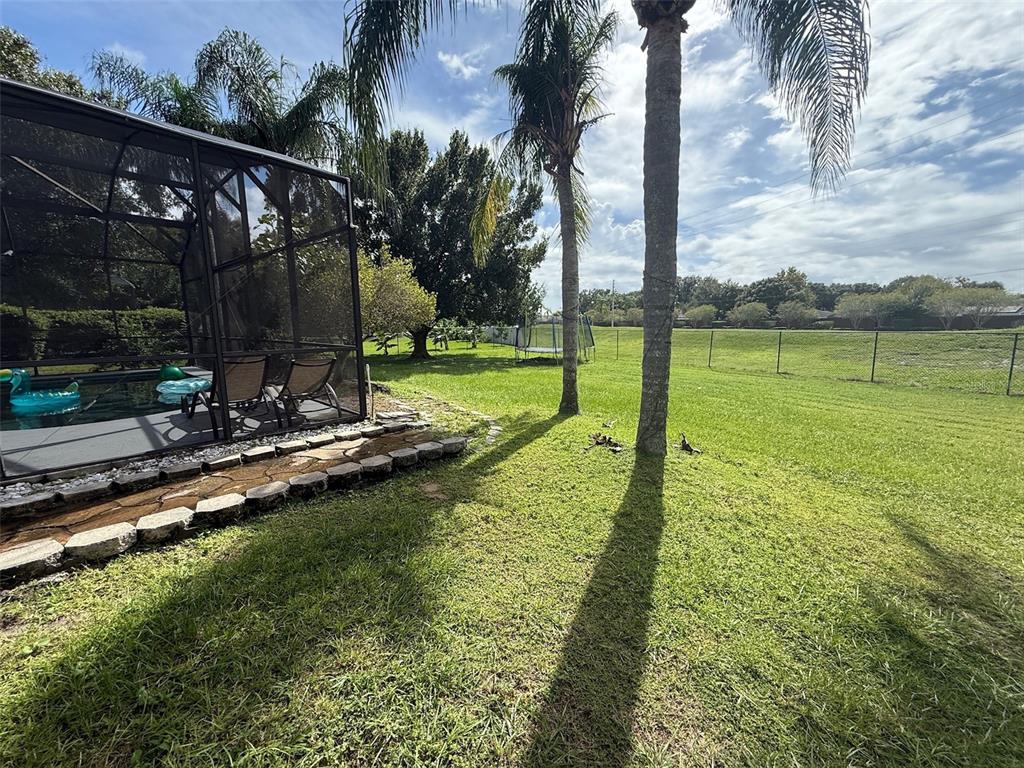 5690 Merlin Way St. Cloud, FL 34772 - Photo 43 of 46 a view of a park with swings and slides