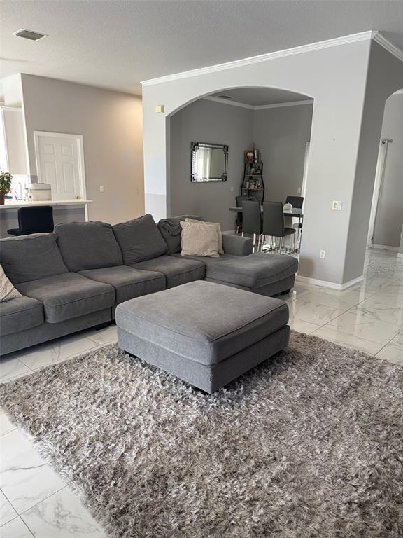 5690 Merlin Way St. Cloud, FL 34772 - Photo 6 of 46 a living room with furniture and a mirror