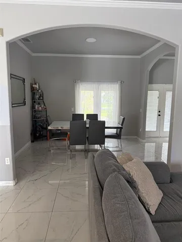 a living room with furniture and large windows