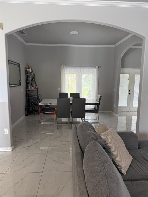 5690 Merlin Way St. Cloud, FL 34772 - Photo 7 of 46 a living room with furniture and large windows