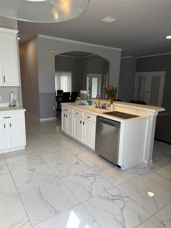 5690 Merlin Way St. Cloud, FL 34772 - Photo 10 of 46 a kitchen with stainless steel appliances a sink stove and cabinets