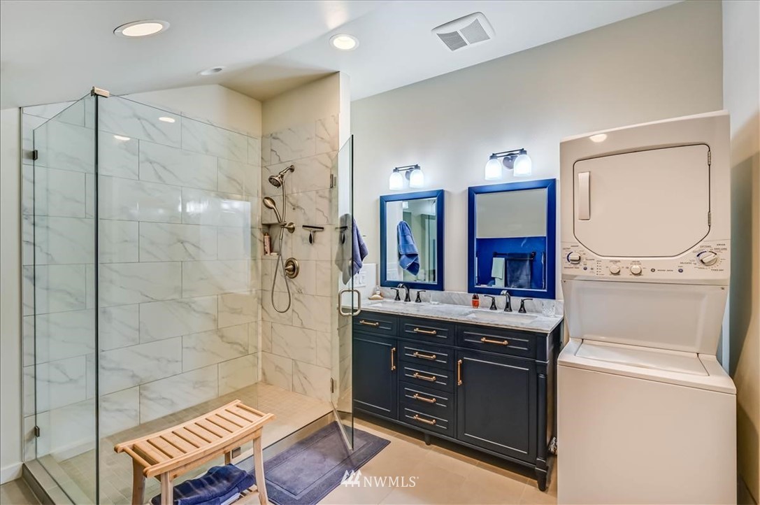 1908 Rucker Avenue Everett, WA 98201 - Photo 16 of 36 a spacious bathroom with a granite countertop sink a mirror a bathtub and shower