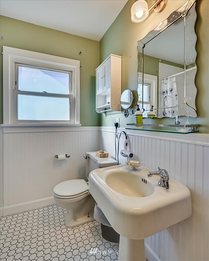 1908 Rucker Avenue Everett, WA 98201 - Photo 20 of 36 a bathroom with a sink a toilet and a mirror