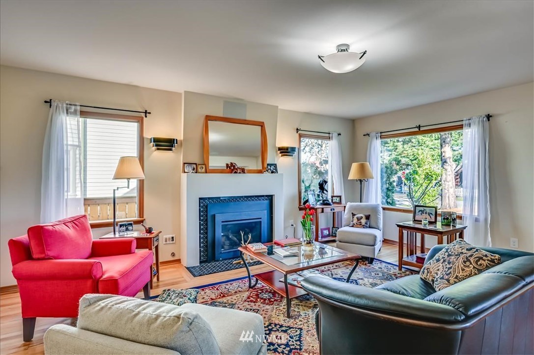 1908 Rucker Avenue Everett, WA 98201 - Photo 2 of 36 a living room with furniture fireplace and a large window
