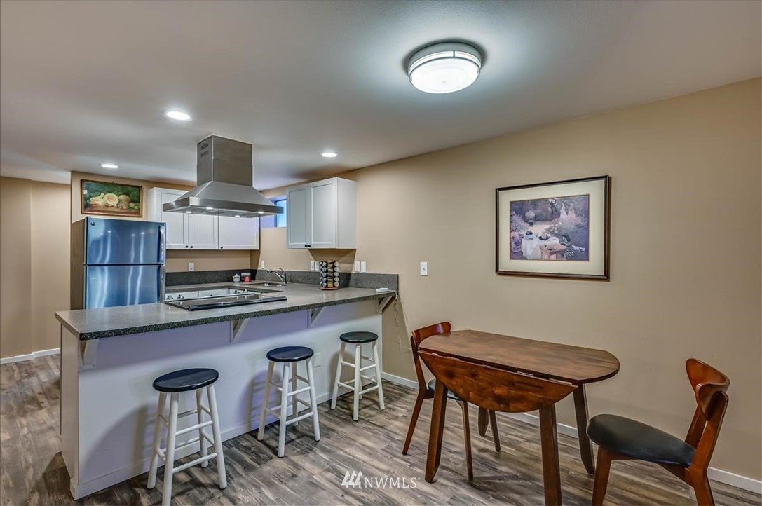 1908 Rucker Avenue Everett, WA 98201 - Photo 23 of 36 a view of a kitchen with kitchen island dining table and chairs