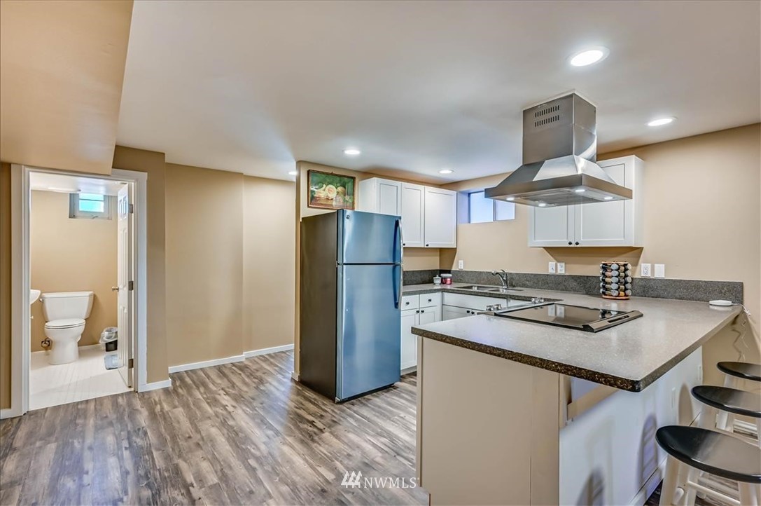 1908 Rucker Avenue Everett, WA 98201 - Photo 25 of 36 a kitchen with stainless steel appliances granite countertop a refrigerator a stove and a wooden floors