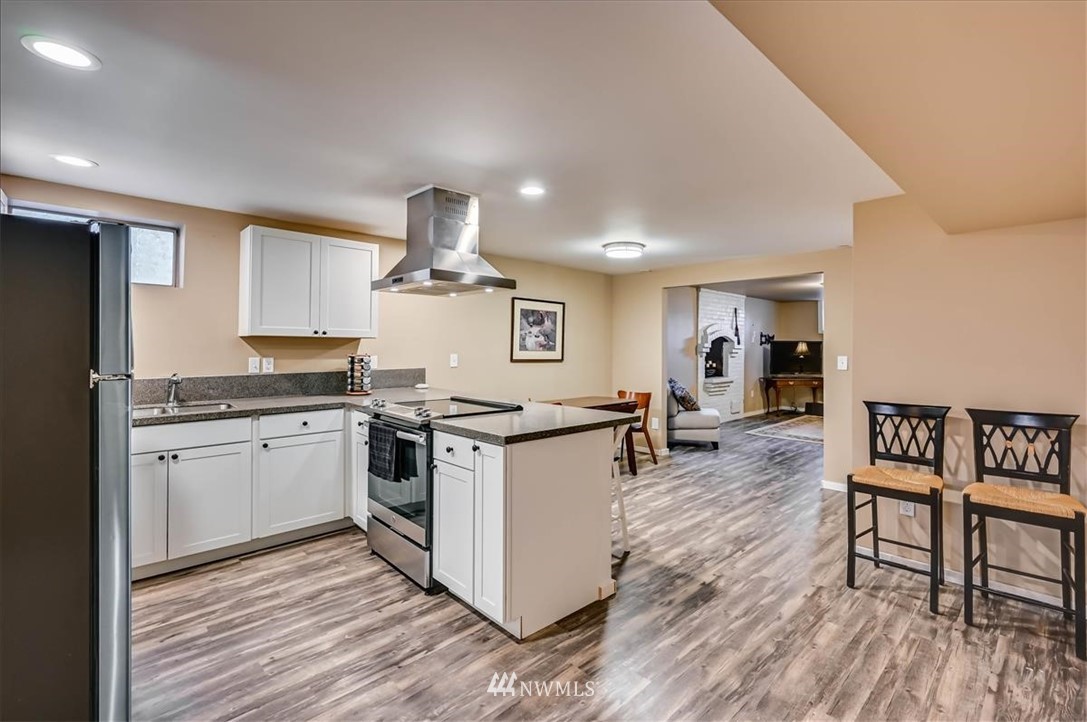 1908 Rucker Avenue Everett, WA 98201 - Photo 26 of 36 a kitchen with stainless steel appliances a stove a sink dishwasher and a refrigerator