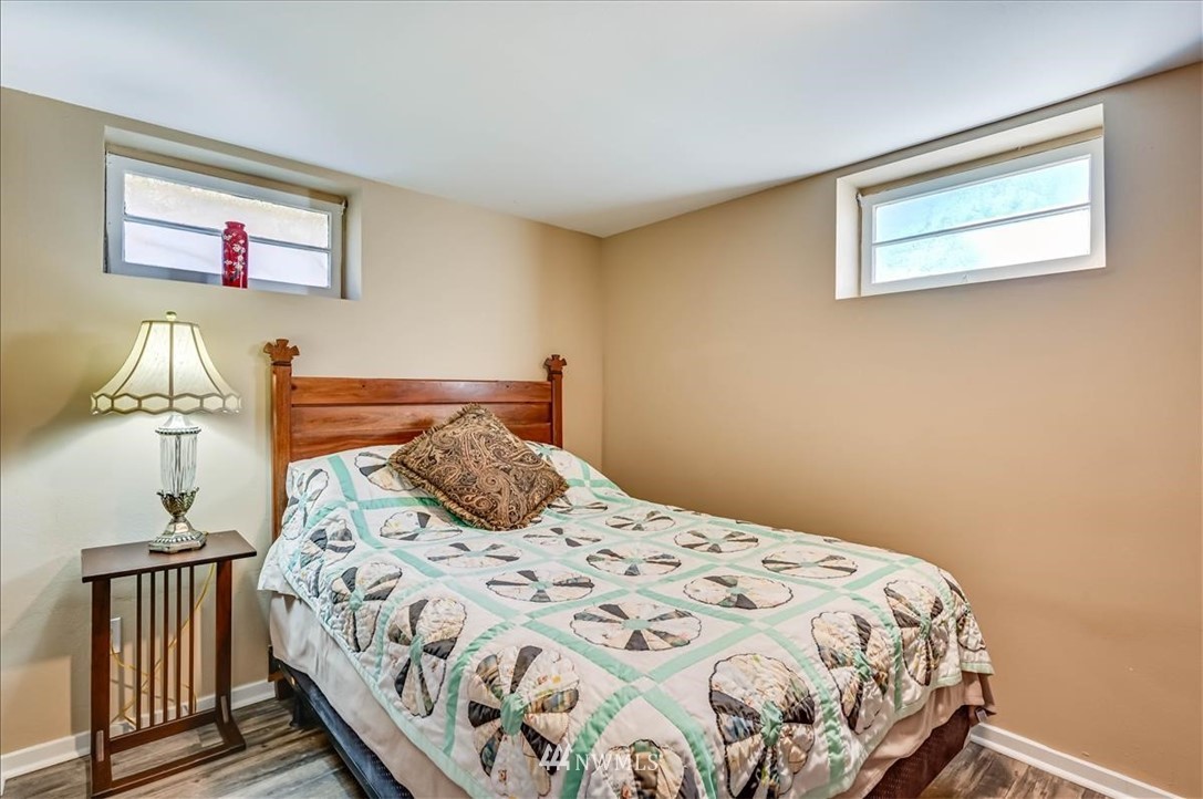 1908 Rucker Avenue Everett, WA 98201 - Photo 27 of 36 a bedroom with a bed and wooden floor