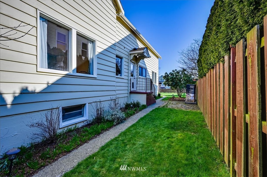 1908 Rucker Avenue Everett, WA 98201 - Photo 29 of 36 a view of a house with brick walls and a yard with a large tree