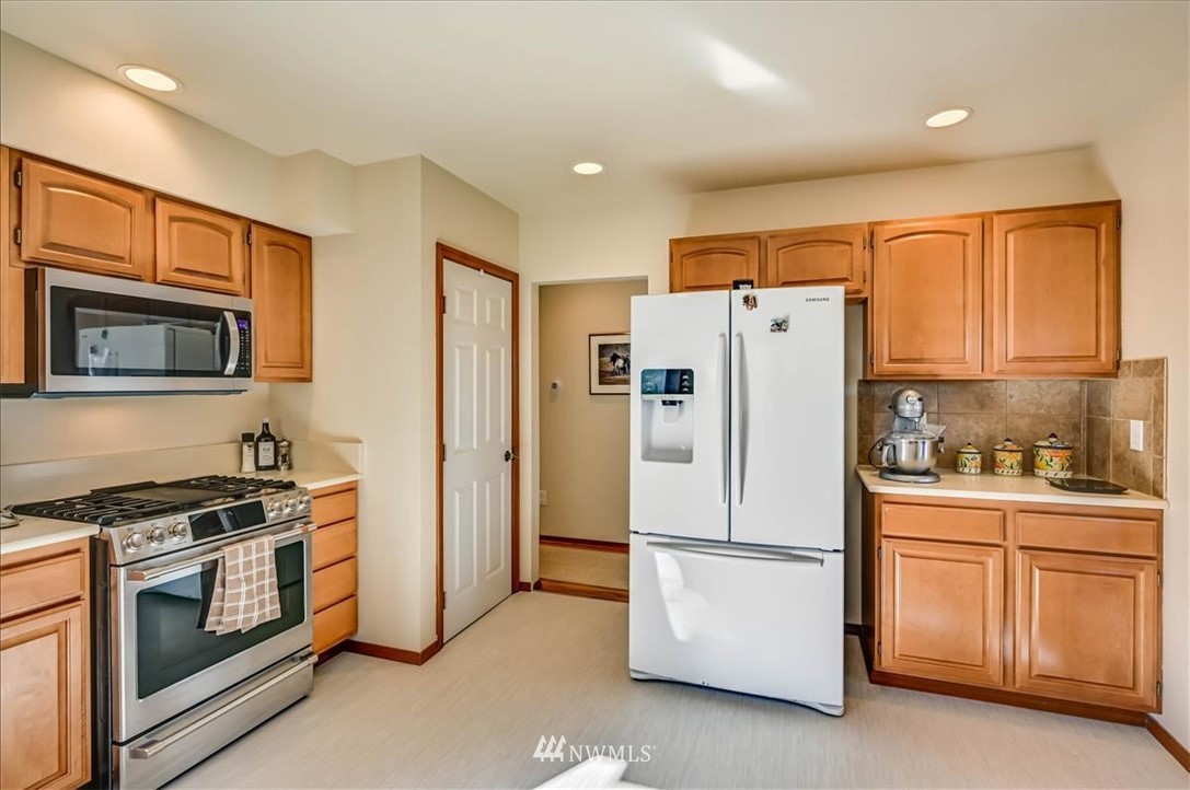 1908 Rucker Avenue Everett, WA 98201 - Photo 7 of 36 a white refrigerator freezer and a stove in a kitchen