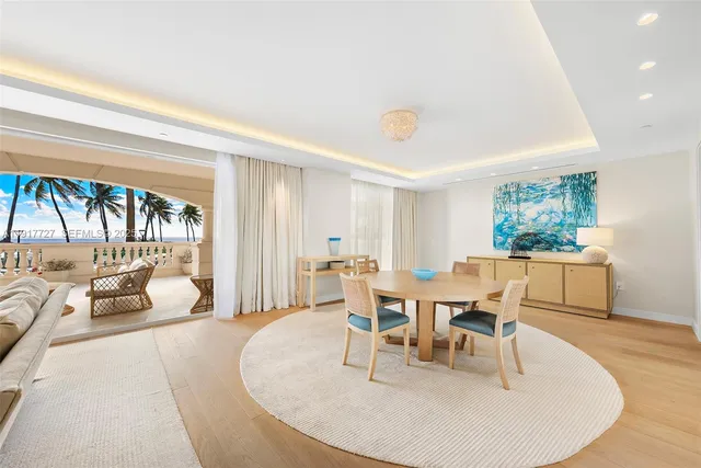 a dining room with furniture and wooden floor