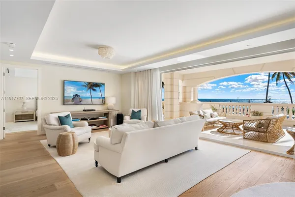 a living room with furniture and a floor to ceiling window