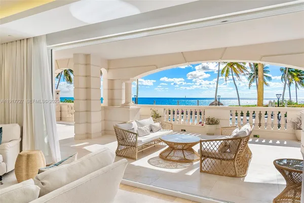 a dining room with furniture and a large window