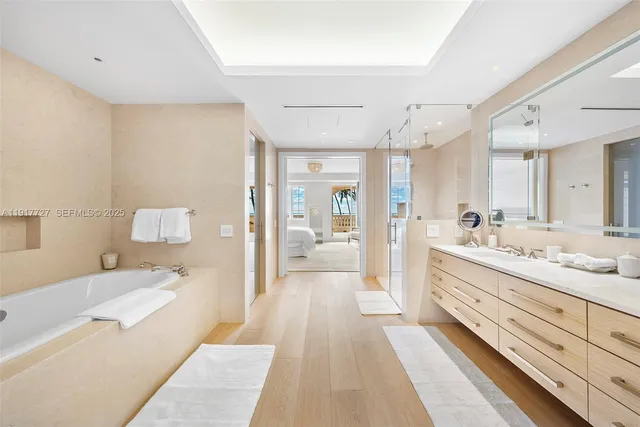 a spacious bathroom with a tub sink and shower