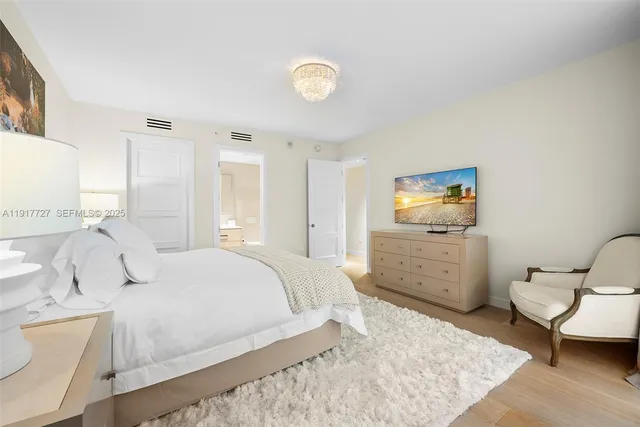 a bedroom with a bed and a view of bathroom