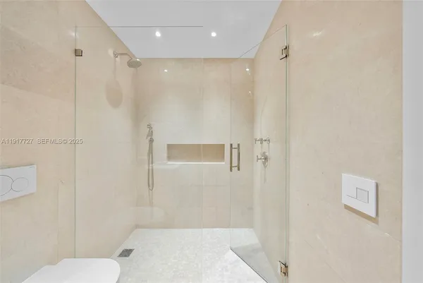 a bathroom with a shower a toilet and sink