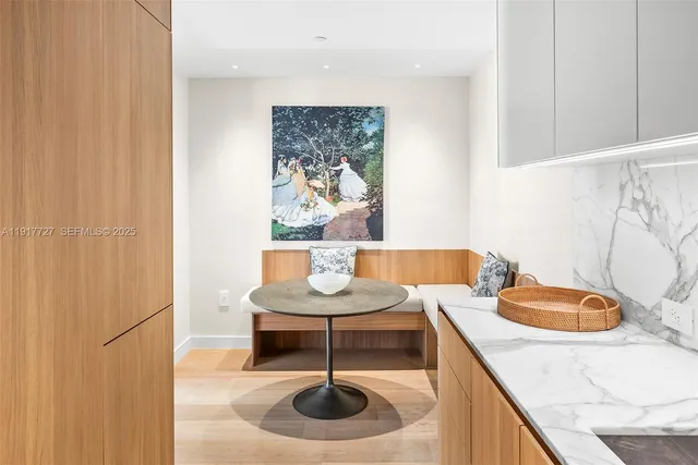 a dining room with furniture and a potted plant