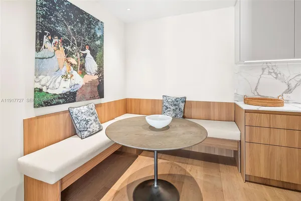 a living room with furniture and a painting on the wall