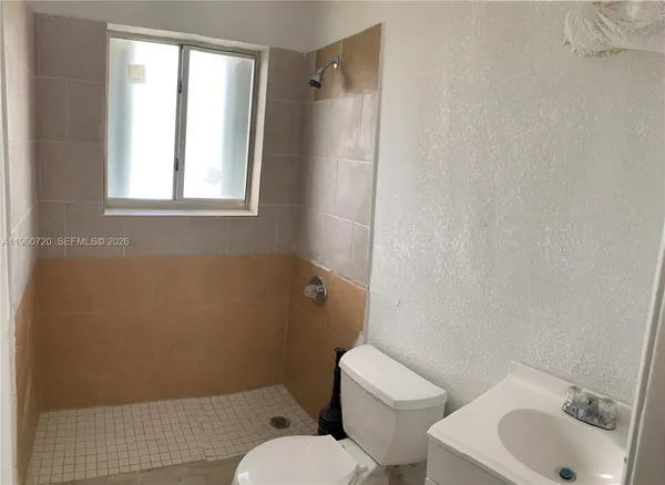 a white toilet sitting next to a bathroom sink