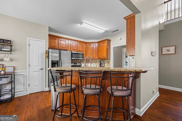 a living room with furniture and a book shelf