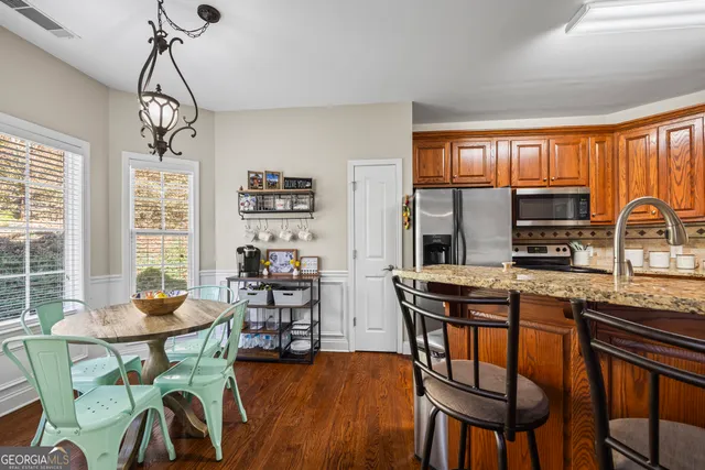 a spacious bathroom with a granite countertop sink a mirror and shower