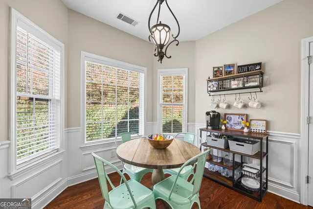 a bathroom with a granite countertop sink a large mirror and a shower