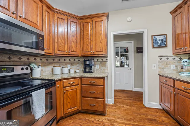 a view of a hallway with closet and wooden floor