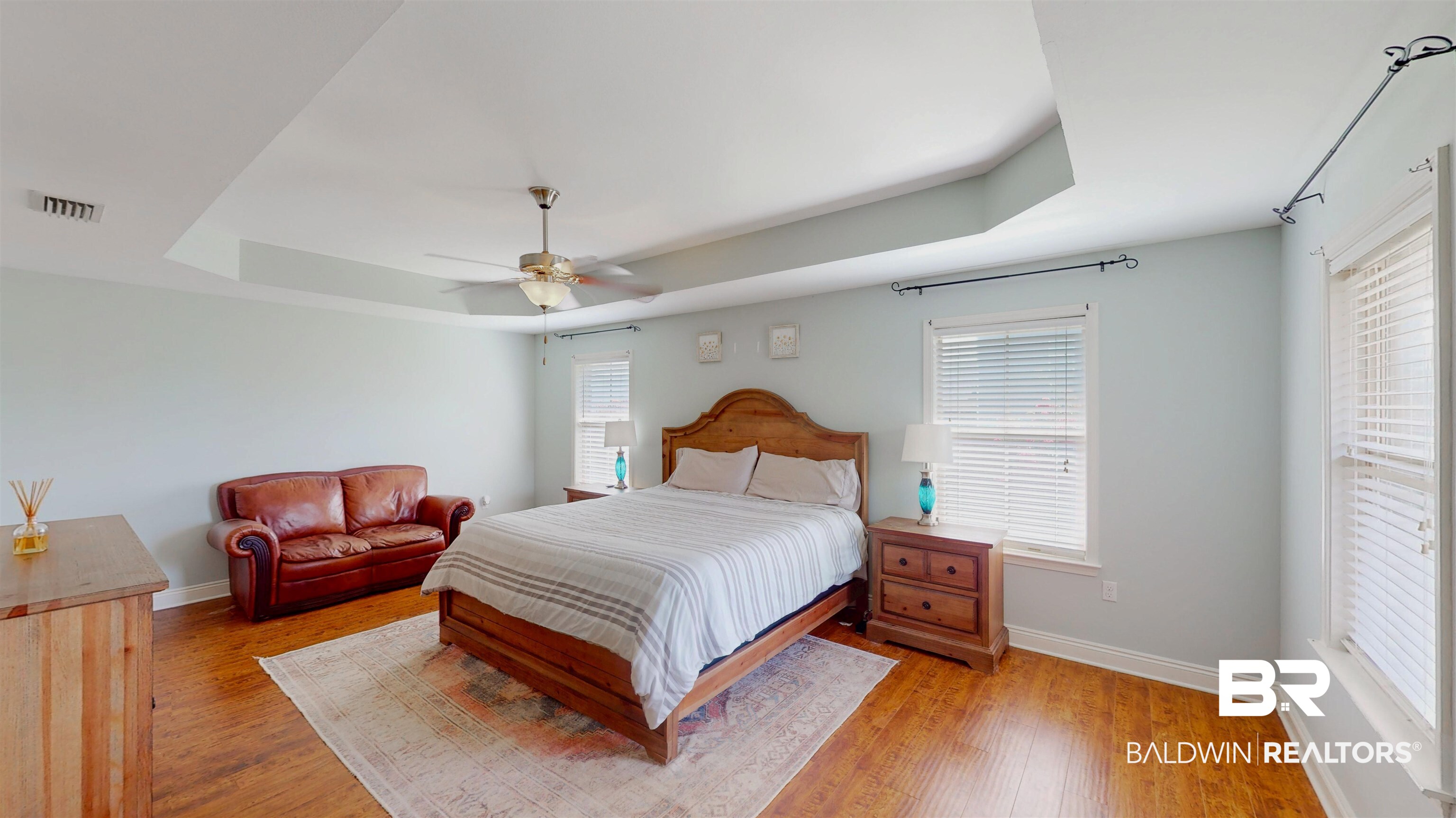 1704 Arcadia Drive Foley, AL 36535 - Photo 30 of 52 Bedroom with a raised ceiling, light wood-type flooring, and ceiling fan