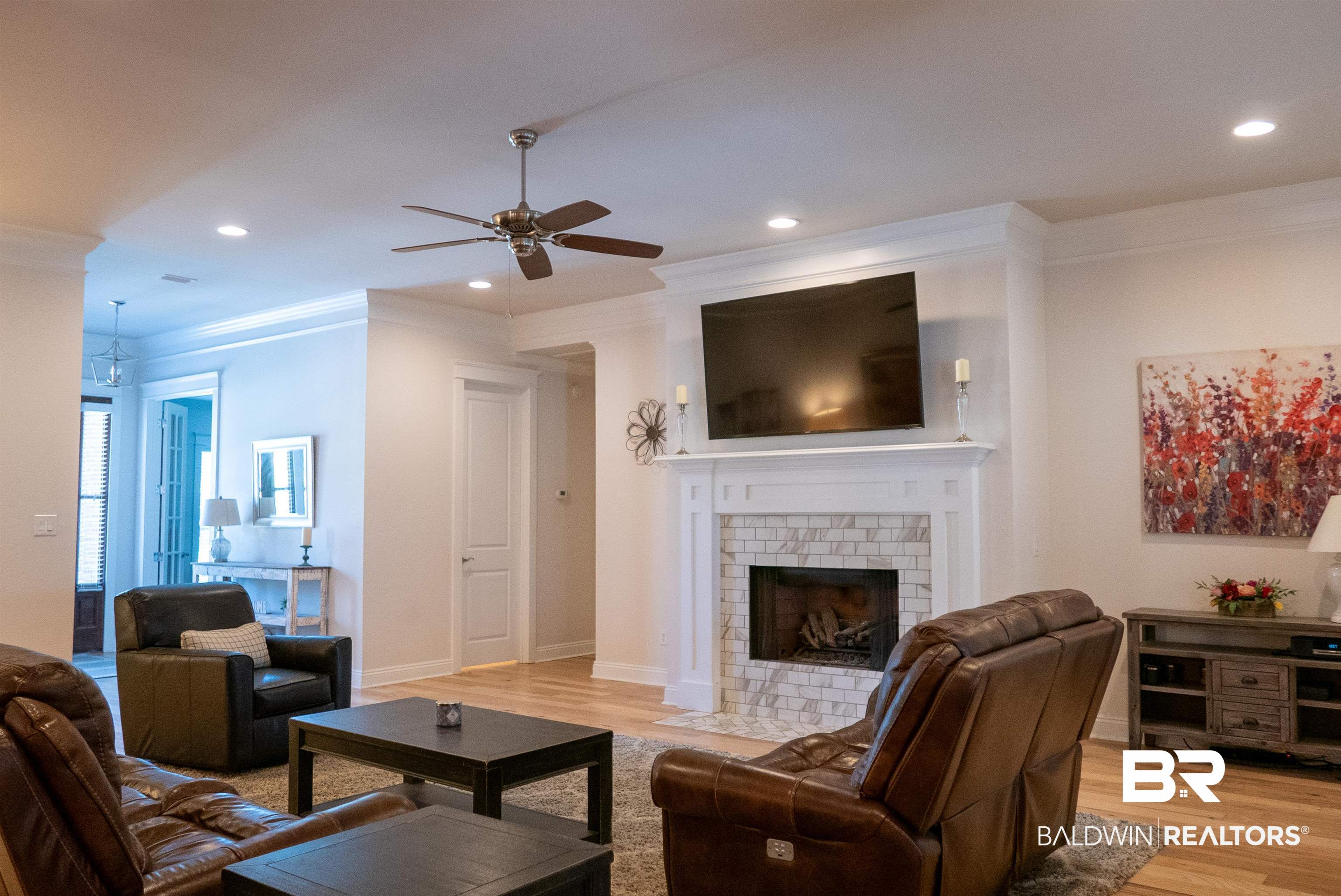6684 Garrison Drive Daphne, AL 36527 - Photo 6 of 35 Living room featuring ceiling fan, ornamental molding, light wood-type flooring, and a fireplace