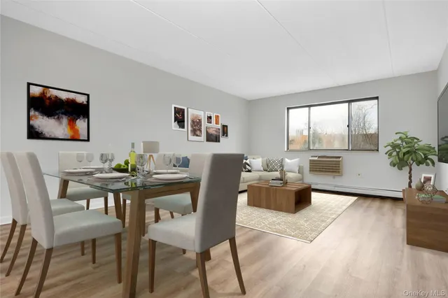 a view of a dining room with furniture and a potted plant